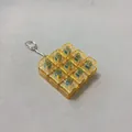 Detail of transparent amber 9-key mechanical switch fidget toy keychain with metal ring - Transparent Yellow