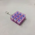 Close-up of 9-key mechanical switch fidget keychain with purple transparent caps. - Transparent Light Purple