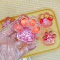 Strawberry cat paw squishy toy featuring pink glitter and translucent texture for stress relief. - Carrot Style (7cm)