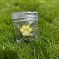 Cute yellow and white cat paw squishy toy in clear plastic bag with green chain. - Yellow Base White Paw