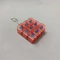 9-key mechanical switch fidget keychain in transparent red PC finish detail view. - Transparent Red