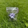 Cute purple and white cat paw squishy stress relief toy in a clear plastic zipper bag - Purple Base White Paw