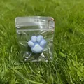 Blue and white cat paw squeeze toy for stress relief in a clear bag with beaded chain - Blue Base White Paw