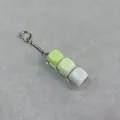 Detailed close-up of a mechanical switch fidget keychain with three gradient green keycaps - 3-Key Linear Style (6260846758367) / Non-Luminous - Blister Card / Bright Green/White Gradient