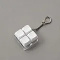 Detail view of a 4-key mechanical keyboard fidget toy keychain featuring white blank keycaps. - 4-Key Grid Shape