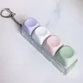 Four key mechanical switch tester keychain with colorful macaron keycaps and clear base - Purple White Pink Green