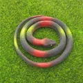 Realistic red and black coiled rubber snake prank toy model on green grass background. - 70cm Grass Snake / Red Gradient