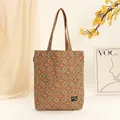 Close-up detail of a Bohemian style cork tote bag with geometric patterns and shoulder straps - Green Argyle Tote Bag