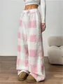 Close-up of soft pink and white checkered fleece pajama pants with loose fit for winter - S / Bottoms / Pink Grid