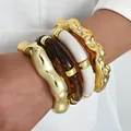 Stylish set of four chunky irregular gold and acrylic bamboo-style bangle bracelets - Irregular Wave Bamboo Bangle (6685001HB) / Four-Piece Set / Gold White Brown Combo