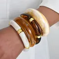 Set of chunky acrylic resin bracelets in amber and marble white with gold metal accents - Thick Irregular Geometric Bangle (6685101HB) / Three-Piece Set / Amber Marble Pattern Combo