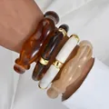Set of four chunky acrylic bracelets in brown, white and beige with gold accents. - Irregular Wave Cylinder Bangle (6685701HB) / Four-Piece Set / Brown Series Set