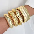 Set of chunky gold acrylic bangles featuring irregular twisted and ribbed designs. - High Polish Geometric Bangle (6686201HB) / Four-Piece Set / High Shine Gold