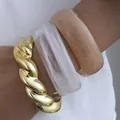 Set of three elegant acrylic and twisted gold-tone bangles featuring a minimalist design - Twist Geometric Bangle Set (6755401) / Three-Piece Set / Gold White Nude Orange Combo