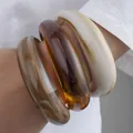 Set of three irregular acrylic open bangles in cream, amber and marbled brown finish - 6109533416058 / Irregular Wave Bangle Set (6745401) / Cream White/Amber/Marble Grey-Brown Combo