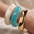 Set of irregular acrylic and gold-tone bangles in cream and blue marble finishes - 3-Piece Water Ripple Bangle Set (6754701) / Beige/Lake Blue/Gold Combo
