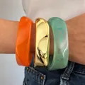 Set of chunky irregular acrylic and gold-tone metallic resin bangles in vibrant colors - 3-Piece Irregular Wide Bangle Set (6754801) / Orange/Gold/Mint Green Combo