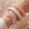 Elegant set of irregular acrylic open bangles in soft pink and cream tones on wrist - 3-Piece Acrylic Wave Bangle (6775101HB) / Pink/Cream Combo