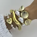 Stylish chunky gold wavy bangle and pearl heart bracelet set for a statement look - 4-Piece Jewelry Set (6708401HB) / Gold and Pearl White Combo