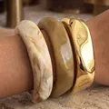 Stackable chunky bangle set with marble acrylic and polished gold metal bracelets - 3-Piece Stacking Bangle Set (6754601) / Gold, Cream and Brown Combo