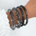 Set of four grey marble acrylic bangles on a wrist, showing elegant textured design. - Ink Pattern Bangle Set (6532802) / Set of 4 / Grey Marble Pattern