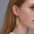 High-quality gold-tone cicada beetle insect dangle earring displayed on a female model - Insect Shape Earrings (7838) / 1 Pair Pack / KC Gold