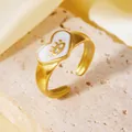 Dettaglio dell'anello a cuore dorato con un simbolo dell'occhio su smalto bianco - Taglia unica / Stile Cuore Malocchio Riempito Bianco (A522)