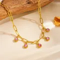Detailed macro view of gold titanium steel chain necklace with five pink crystal stone charms. - Pink Rhinestone Necklace (F306) / Gold