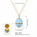 Light blue egg-shaped locket necklace with hidden flower, copper gold plated pendant. - April Flower