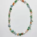 Gros plan de pierres irrégulières colorées et perles d'eau douce sur collier élégant - Ras du cou perlé en pierres naturelles multicolores