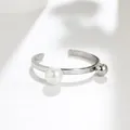 Detailed macro view of minimalist open ring featuring a white pearl and silver ball - US 5 / Silver