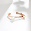 Rose gold open ring with pearl and ball detail on white background - US 5 / Rose Gold