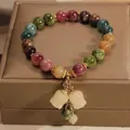 Elegant multi-color gemstone beaded bracelet with white tulip floral pendant charms. - Tulip Pendant Style (WG-0793) / Gold With Multi-Color Beads