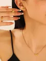 Detailed view of model wearing a golden heart jewelry set with necklace and earrings. - 18K Real Gold (3-Piece Set)