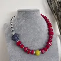 Detail of vintage beaded necklace with red natural stones and blue heart pendant. - Style 17 (Necklace)