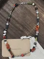 Detail of handmade vintage natural stone beaded necklace on wooden background. - Style 23 (Necklace)