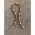 Close-up of orange natural stone beaded necklace with pearl detail and gold-tone chain - Style 33 (Necklace)