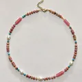 Macro detail of a vintage beaded necklace featuring pink rhodonite beads and baroque pearls - Style 34 (Necklace)