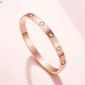 Elegant rose gold titanium steel bangle bracelet with flower motifs and sparkling crystals - Rose Gold Clover Engraved Style