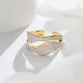 Close-up of irregular wavy gold-plated titanium steel ring with white marble enamel detail - One Size / White Enamel Style (B358)