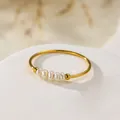 Detailed macro shot of an elegant gold titanium steel ring with five baroque pearls - US 7 / Baroque Pearl Thin Ring Style (b191) / Gold