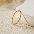 Macro shot of gold-plated titanium steel twisted rope ring with elegant minimalist texture - US 7 / Thin Twisted Rope Style (B252) / Gold