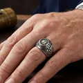 Close-up view of vintage stainless steel United States Veteran ring on hand - Size 7 / Steel