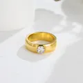 Detail view of a gold-toned titanium steel ring with a sparkling round zircon stone - US 7 / White Zirconia Gold Ring