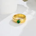 Detailed macro shot of a gold titanium steel ring with a round green zircon - US 7 / Green Zirconia Gold Ring