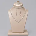 Elegant bridal crystal jewelry set including necklace earrings and ring on gold display stand - Versatile Party Jewelry Set (NS-J6576S) / Silver