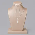 Elegant silver bridal jewelry set with sparkling crystals on a beige display bust - Simple Versatile Jewelry Set (NS-J6568S) / Silver