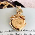Vintage gold heart locket pendant with A Token of Love engraving - LOVE