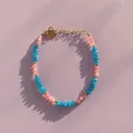 Close-up of bohemian colorful natural stone beaded bracelet with heart charm on purple background - Blue and Pink Mixed Faceted Beaded Style (Bracelet 9)