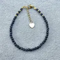 Close-up of bohemian blue natural stone beaded bracelet with gold heart charm. - Deep Blue Faceted Beaded Style (Bracelet 17)